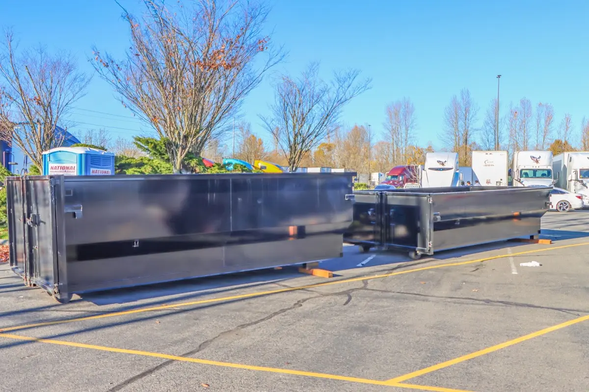 Professional dumpster rental service with roll-off container on residential driveway in Euclid